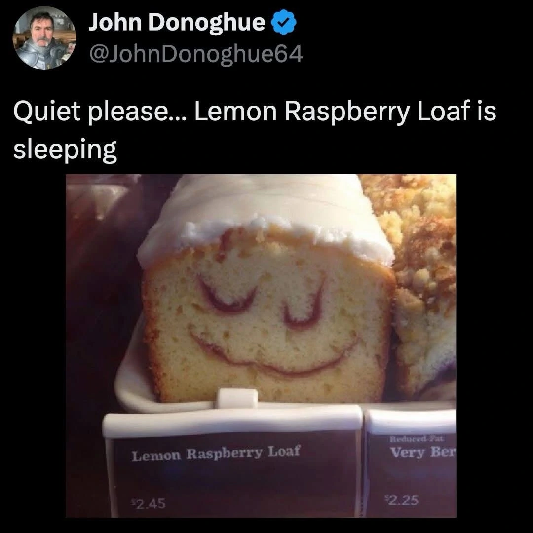 a display at a bakery with a cake that looks like it's peacefully sleeping